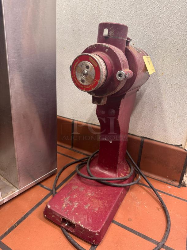 Tomlinson CM-400 commercial coffee grinder, red, vintage, showing wear. Knob indicates grind settings. Cord attached.