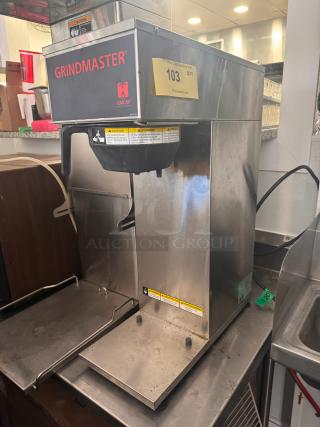 Grindmaster GMCW CPO-SAPP coffee brewer, 120V, stainless steel, commercial-grade. Minor wear, safety and auction labels visible.