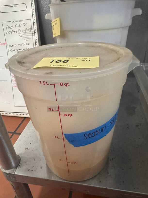 8 quart food storage container with lid, marked up to 8 quarts and labeled "season salt," in used condition.