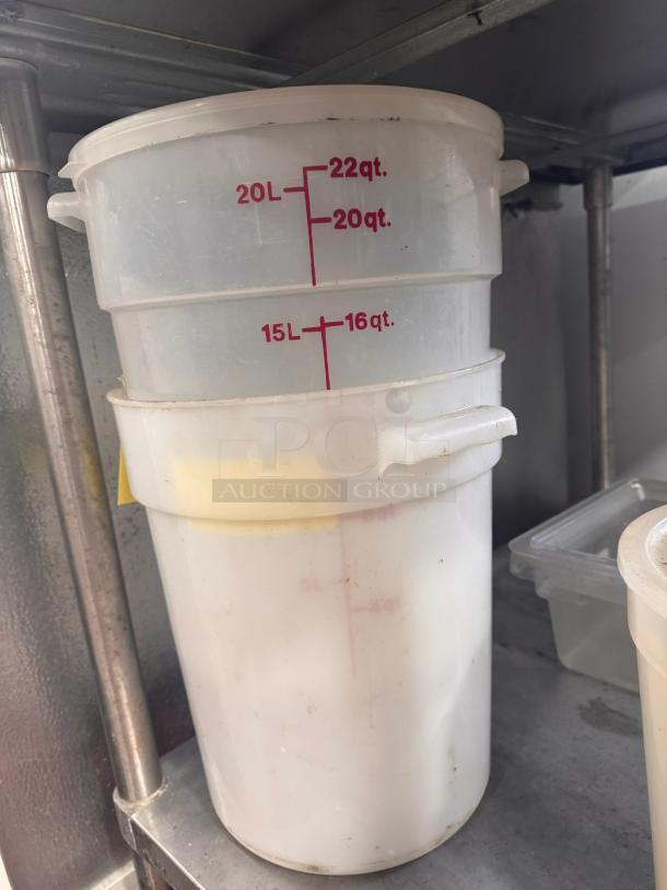 Lot of 2 clear 22-quart food storage containers; visible volume markings; slight wear; handles on sides.