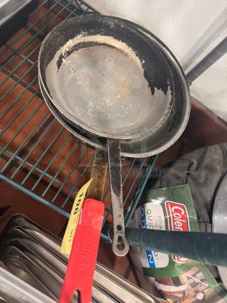 Lot of 2 used skillets with visible wear on non-stick surface, metal handles, tagged with item number 102, labeled "Winco."