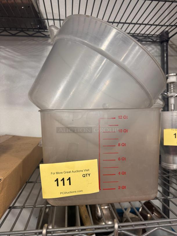 Lot of 2 clear food storage containers, including a 12 qt marked container, both in used condition. Auction tag visible.