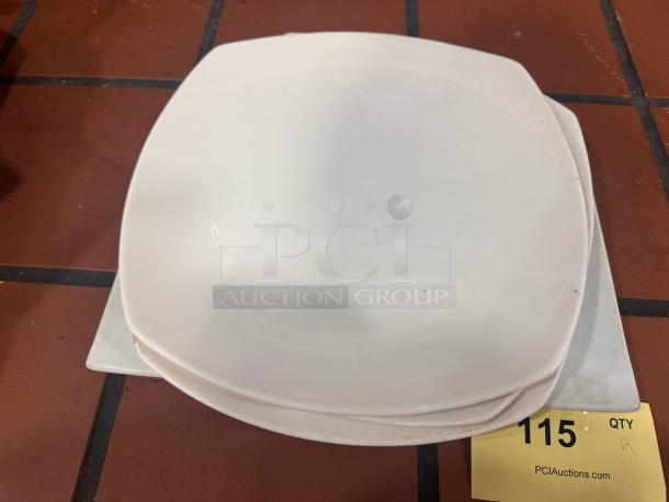 Porcelain dinner plate BIDX4, square, white, slight edge wear, stacked, label "115 QTY" on note from PCIAuctions.com.