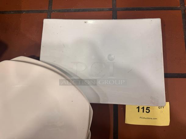 Porcelain dinner plate BIDX4, rectangular shape, minimal wear, white finish, item tag 115 visible.