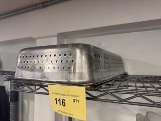 Perforated stainless steel food pan on metal shelf, showing light wear. Auction tag visible, marked "116, QTY 2."