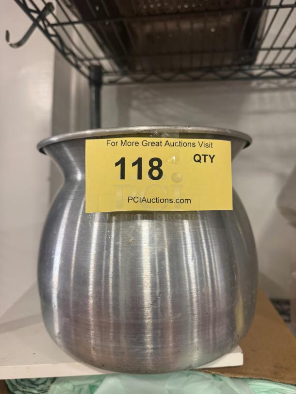 Aluminum sticky rice pot with wide rim, used condition. Auction tag reading "118" from PCIauctions.com attached.