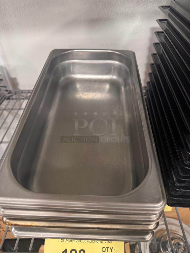 Stainless steel food pan BIDX6, rectangular, excellent condition, stackable, visible minor surface wear.