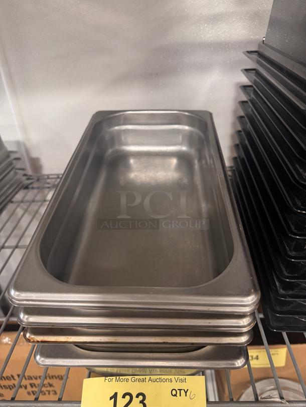 Stainless steel food pan BIDX6, stackable, shows slight wear. Quantity 6, in good condition, ideal for catering use.