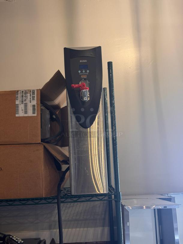 BUNN hot water dispenser with digital display, red tap, stainless steel body, and compact design; good condition.