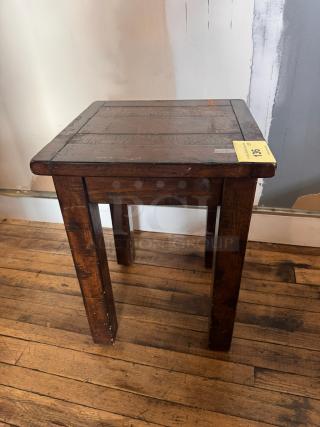 Vintage wooden side table with rustic finish, square top, and sturdy legs. Visible wear adds character. Auction tag: "136."