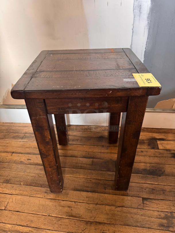 Vintage wooden side table with visible wear, rectangular top, robust legs, and a tag marked "136."