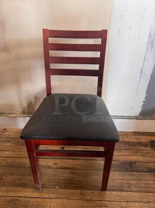 Wooden dining chair BIDX3 with ladder back design and black upholstered seat. Some visible wear on legs, overall sturdy condition.