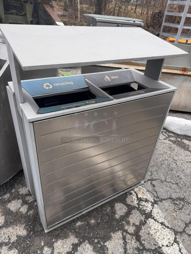 Stainless steel recycling receptacle with separate compartments for recycling and litter, labeled with icons, in good condition.
