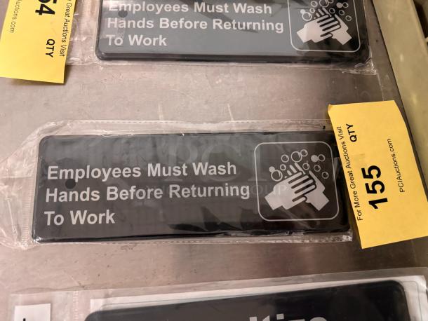 "Employees Must Wash Hands Before Returning to Work" sign, brand new, black background, white text and icon, in packaging.
