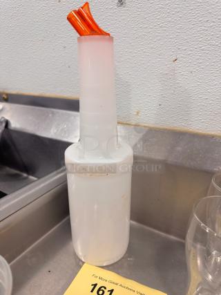 White bar store-and-pour bottle with orange pour spouts, used condition, suitable for efficient bar service.