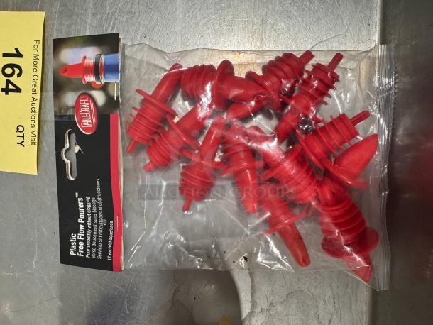 Red plastic pourers by Tablecraft in original packaging, labeled "Free Flow Pourers," ideal for smooth pouring. Quantity: 12.