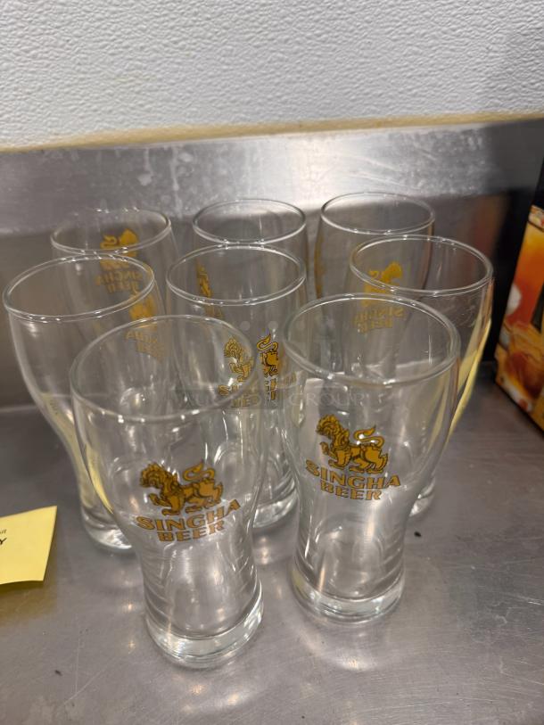 Lot of 8 Singha Beer glasses, clear with gold logo, excellent condition, perfect for collectors or enthusiasts.