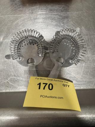 Two metal bar strainers with coiled springs on a stainless steel surface, labeled "170" at PCI Auctions.