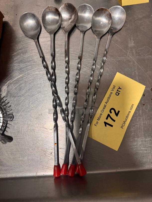 Set of six BIDX6 bar spoons with twisted handles and red tips, in good condition. Auction tag reads "172 QTY."