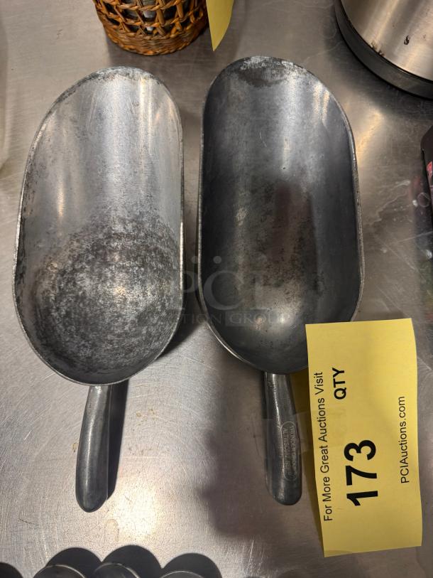 Lot of 2 metal bar scoops, used condition, silver tone, visible wear, sturdy handles, auction tag 173.
