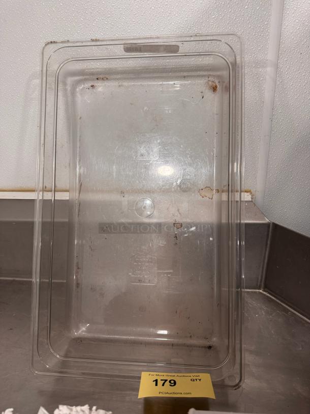 Clear 1/1 X 4in food container, used condition with visible stains, label on bottom indicating model 179, auction note present.