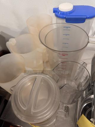 Lot of miscellaneous pitchers, various sizes and colors, with measurement markings. All items sold together.