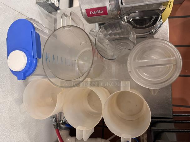 Lot of miscellaneous plastic pitchers, various sizes, some with lids, fair condition, includes Estella-marked pitcher.