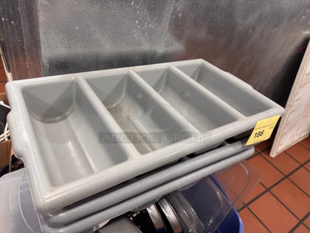 Lot of 3 gray plastic cutlery bins. Each bin has four compartments. Used condition with minor scratches. Auction tag "186".