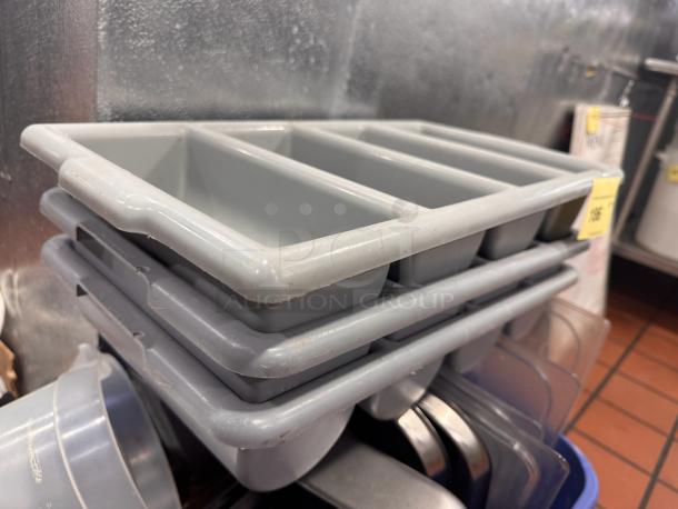 Lot of 3 gray plastic cutlery bins, stackable, divided compartments, used condition, ideal for organizing utensils.