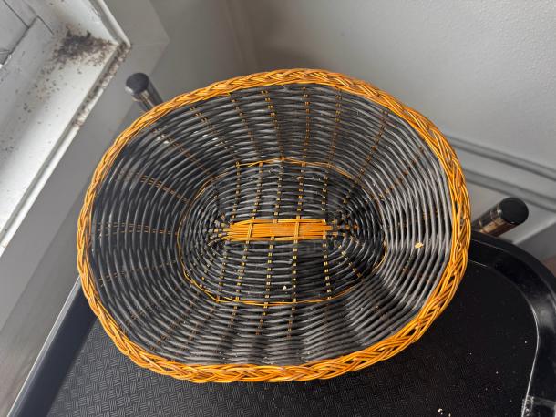 Ornate woven basket, model BIDX19, featuring black and orange design. Appears in good condition.