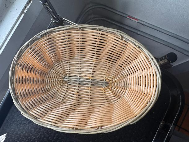 Oval wicker food basket, light brown, used condition, with a woven design, suitable for storage or display.