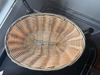 Oval wicker food basket, light brown, used condition, with a woven design, suitable for storage or display.