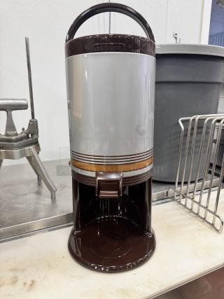 Brand new thermal beverage dispenser with brown and silver design, featuring a handle and tap for convenience.