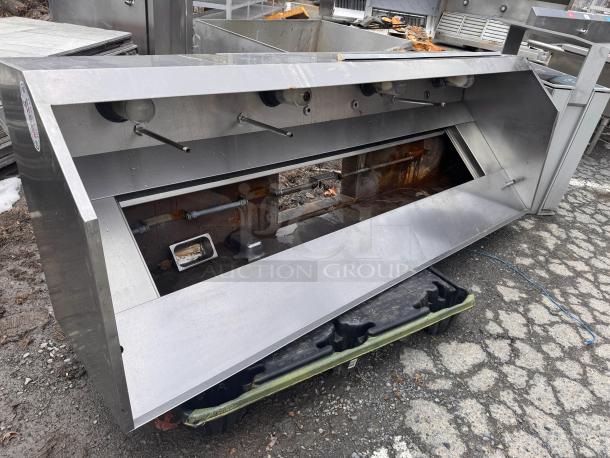 8ft low profile stainless steel exhaust hood, minor rust, industrial use, equipped with grease filters and light fixtures.