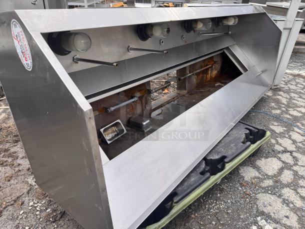 8Ft low profile stainless steel exhaust hood, used, visible wear, label indicates manufacturer details. Suitable for commercial kitchens.