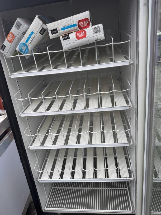 TRUE GDM-26 single glass door refrigerator in working condition, featuring multiple wire shelves and original markings visible.