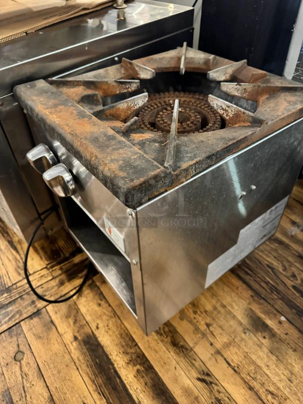 CPG NG Stock pot range in used condition, featuring a heavy-duty cast iron burner and stainless steel body. Visible rust and wear.
