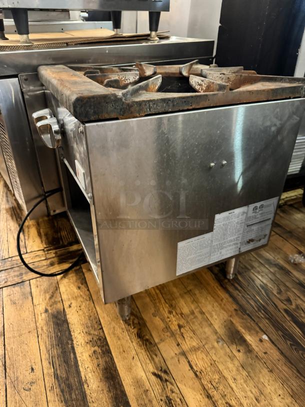 CPG NG Stock Pot Range, stainless steel, single burner, visible rust on top, includes safety labels with usage instructions.