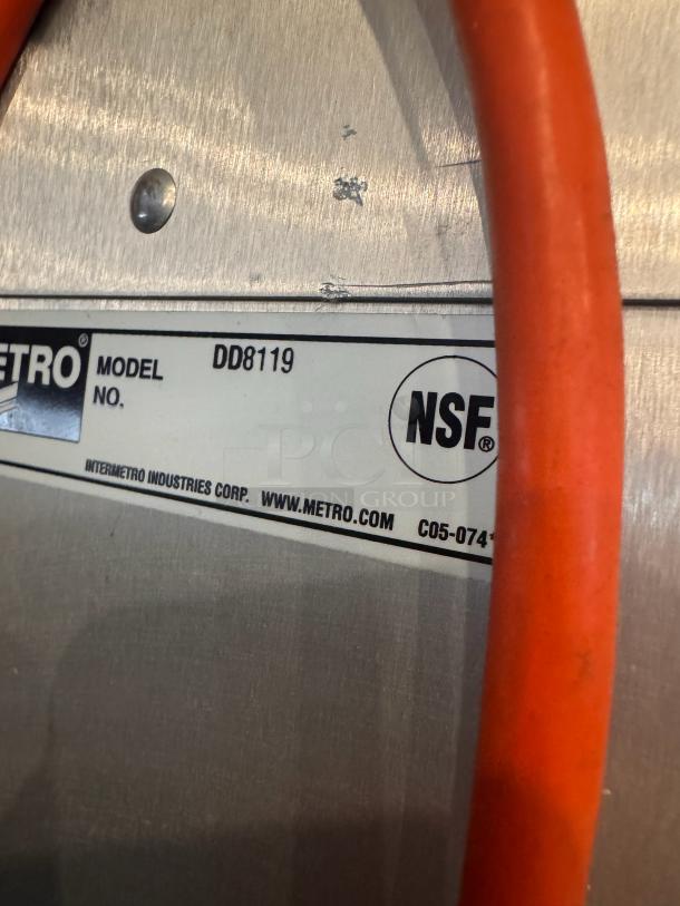 METRO DD8119 holding cabinet, model tag with NSF certification visible, stainless steel surface, slight wear marks.