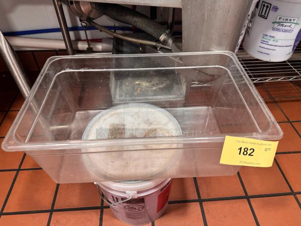 Clear plastic food storage container, 1/1 x 8in size, used condition. Auction lot tag marked "182" visible.