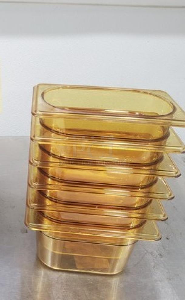 Stack of six 1/9 size, 4-inch deep plastic food pans. Amber color, excellent condition, ideal for kitchen use.