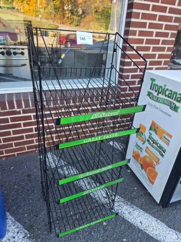 Black metal display rack with four wire shelves, each labeled "All Natural," "Great Taste." In good condition.