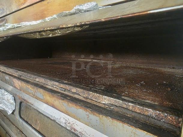 Baker's Aid Double Deck Oven BADO-434HC, used condition, 208V 3ph, featuring two stacked baking decks with visible wear and foil lining.