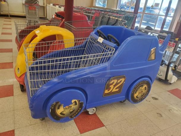Blue race car shopping cart with number 32 decal, featuring front grill design. Minor wear; perfect for child-friendly shopping.