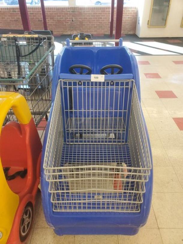 Blue race car shopping cart with steering wheels, metal basket, and visible number tag "109"; gently used condition.
