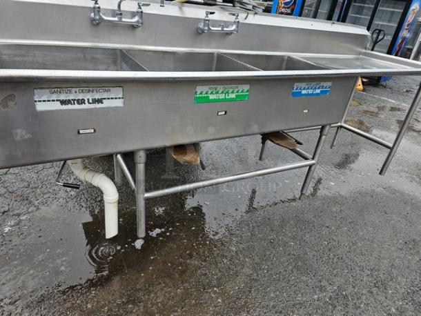 140" three-compartment stainless steel sink with drainboards, labeled water lines, sturdy frame, commercial kitchen use.