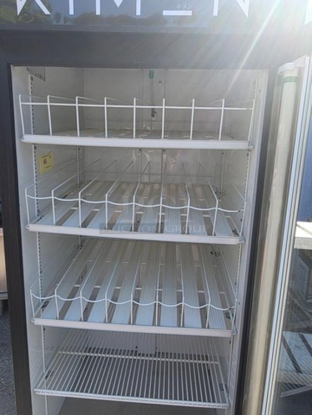 TRUE GDM-26 single deck cooler merchandiser with glass door, multiple adjustable shelves, and steel frame. 