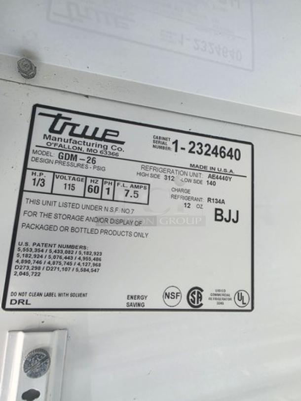 TRUE GDM-26 cooler merchandiser label, detailing model, refrigeration specs, and NSF certification for display use.