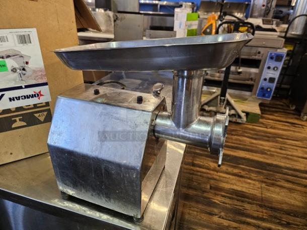 Stainless steel meat grinder model MG-IT-0022-C, 115V, in used condition, with a spacious hopper and visible control knobs.