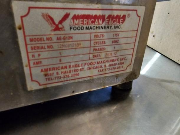 American Eagle meat grinder model AE-G12N, 115V, 60Hz, industrial-grade with visible label showing specs and contact info.